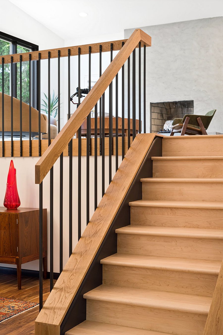 The updated white oak staircase is takes its cue from Midcentury Modern design, connecting the entry level with the first floor.