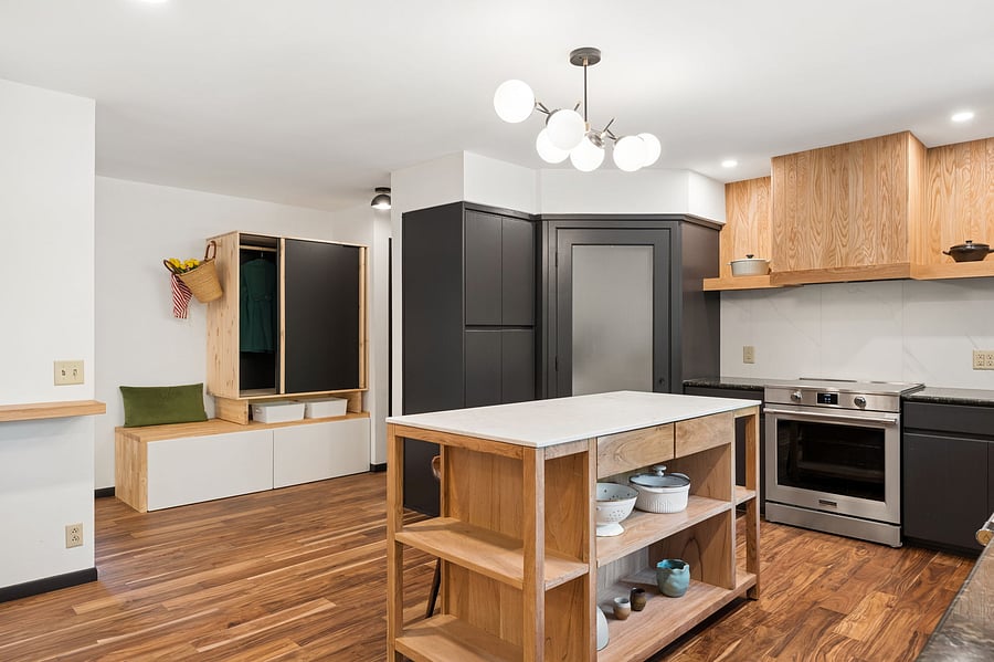 The eat-in kitchen connects directly to main the front entry with handy mudroom storage, a powder bathroom, and the attached garage.