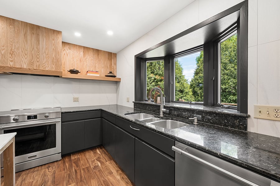 Sunny kitchen window looks directly out onto the deck and back porch. Three chamber sink with integrated garbage disposal and new stainless steel dishwasher.