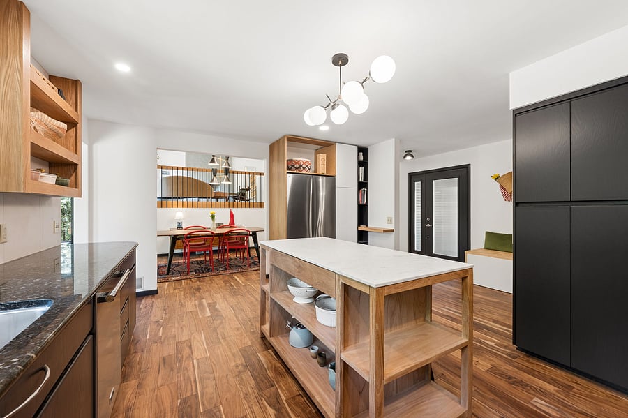 The updated custom kitchen flows seamlessly to both the entry and the dining room, with clear views to the living room.