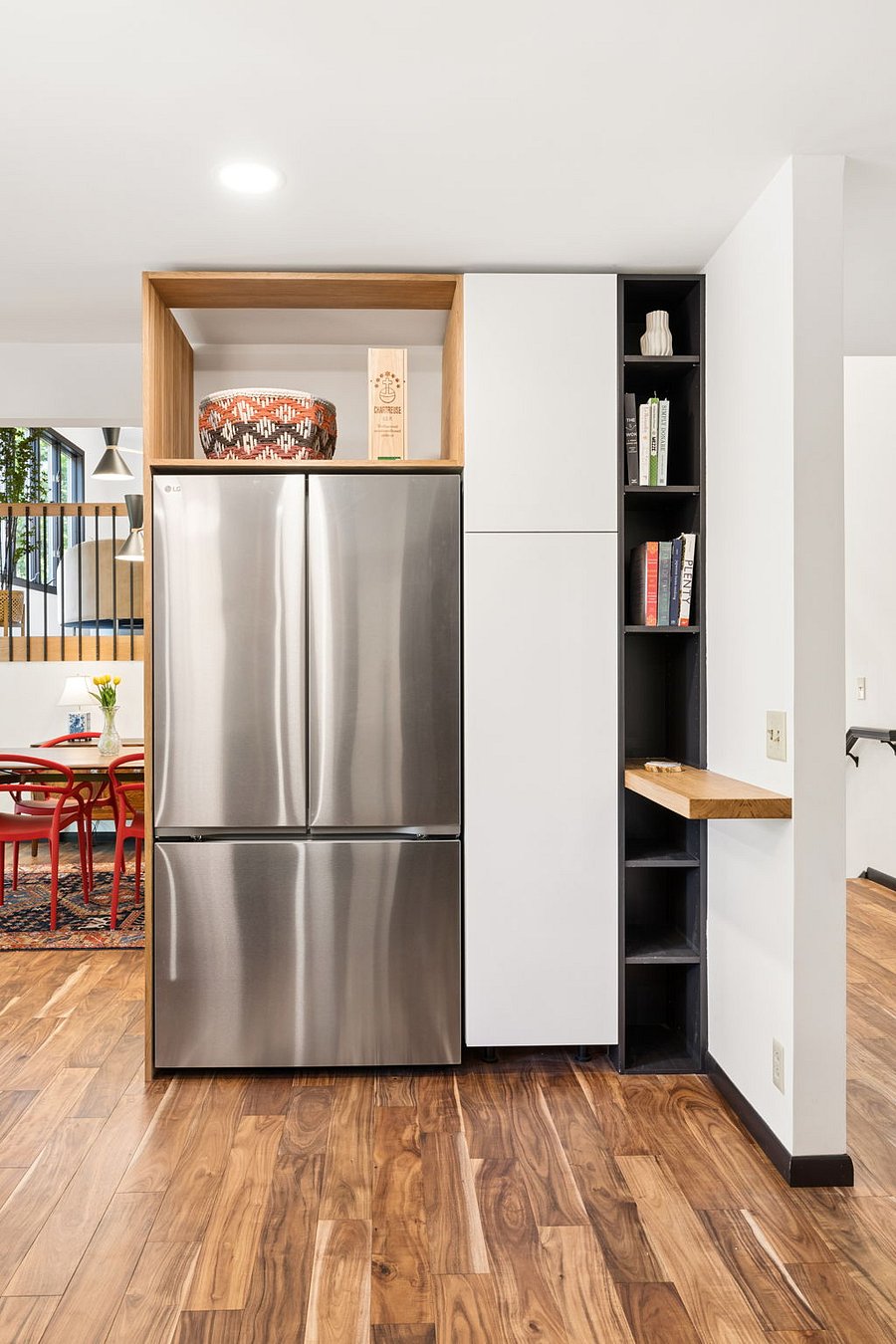 New French door refrigerator with bottom freezer, surrounded by custom cabinetry storage and a handy drop zone for charging your devices.