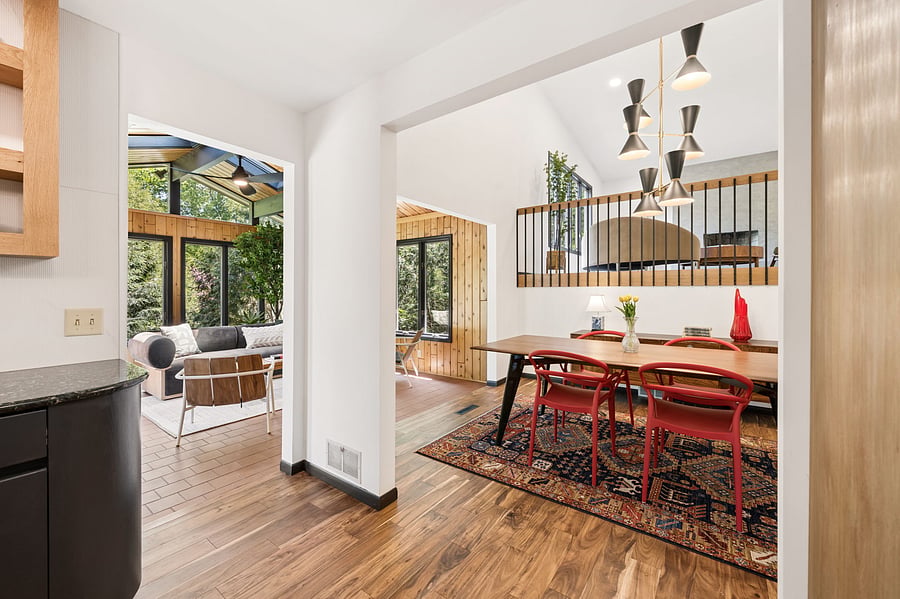 All of the main entertaining spaces in the Nordic Revival flow together beautifully. The updated kitchen connects directly to the sun room and dining room, with clear views to the living room.