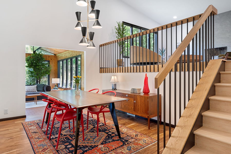 The dining room is centrally located for easy entertaining - flowing directly into the updated kitchen, the sunroom (with the deck and backyard beyond), and the main living room. Large dining table easily seats six. Dinner service + glassware for six+