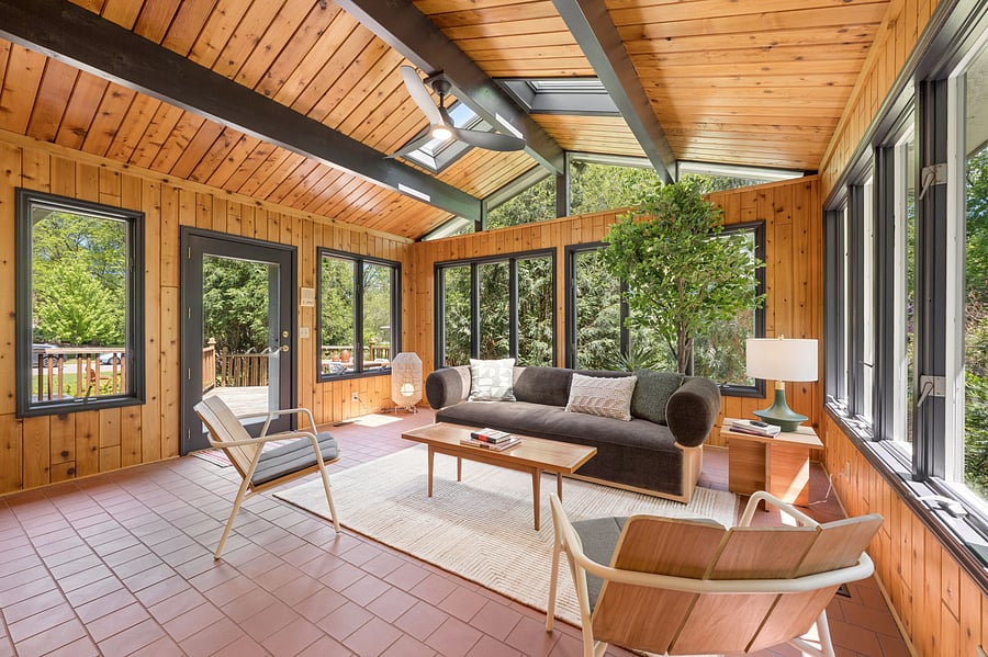 The beautiful sun room looks out onto the backyard and the deck. Curl up with a book, or enjoy your Fika afternoon coffee with friends.