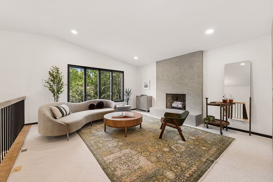 The Nordic Revival has three comfortable living areas, each with their own views and vibes. This is the main living area with forest views and a modern microcement decorative fireplace. Also features a Sony Bravia smart tv for relaxing + entertaining.