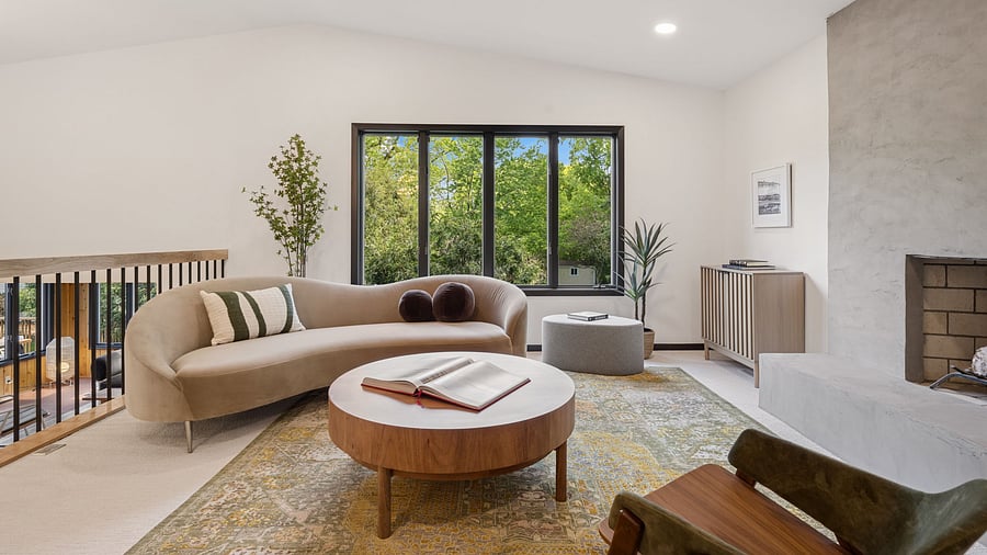 he main living room looks out over the backyard and the wooded lot. Views of nature and plenty of sunshine create a calm and relaxing space.