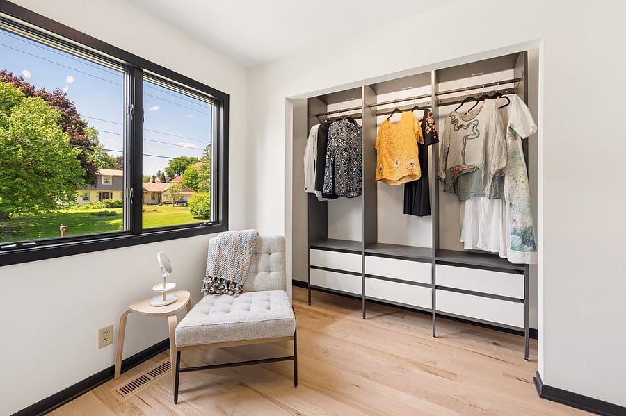 The primary bedroom's large ensuite walk-in closet includes plenty of hanging storage and build in wardrobe for folded clothes. Connects directly to the private primary bathroom.
