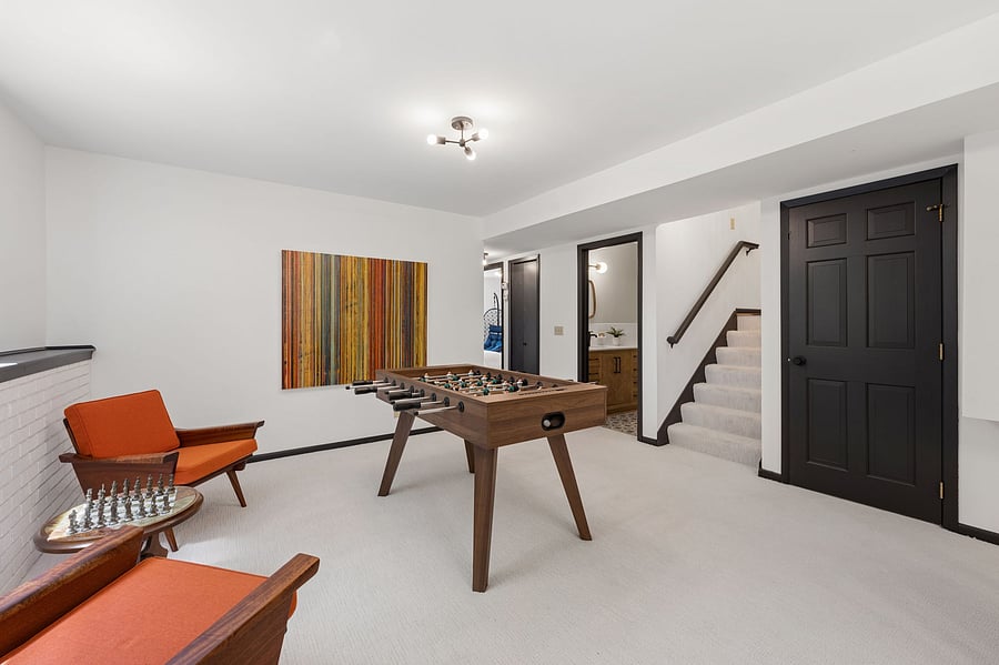 Gather around the foosball table for fun in the ground level family room, or sit down for a game of chess by the window. a full bathroom with tub + shower is right off the family room, with two bedrooms just down the hall.