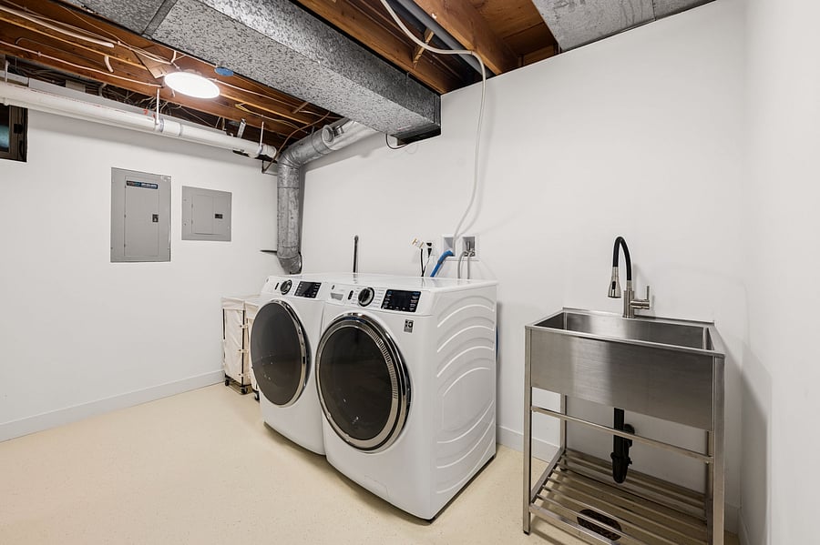 Dedicated laundry room with brand new washer and dryer. Includes a large stainless steel sink for hand wash items. Equipped with an iron and ironing board.