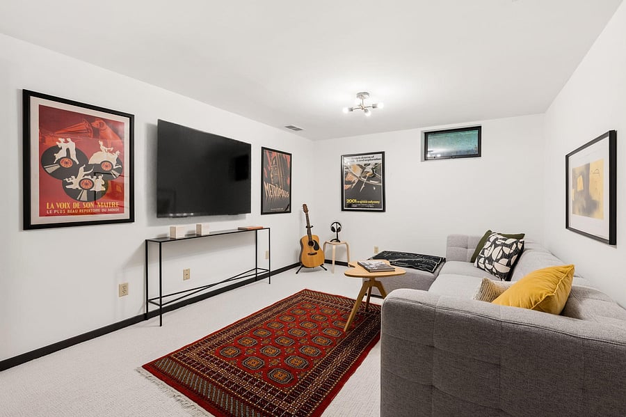 The lower-level bonus room with its own ensuite rounds out the space, Enjoy as a home theater and game room with the wall-mounted 2026 Sony Bravia Smart TV, or extra space for guests.