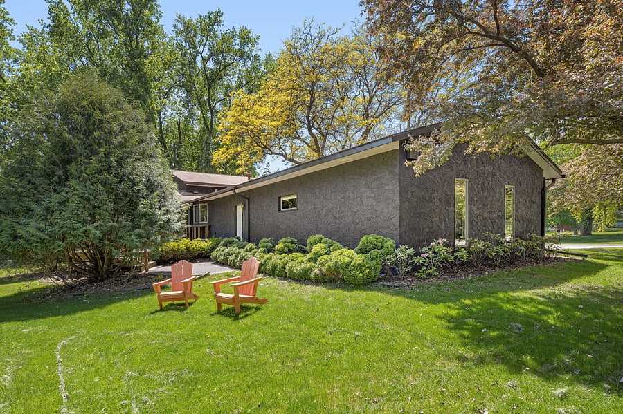 Nearly half-acre wooded corner lot with mature trees and back deck - just a short stroll to natural lake at the end of the quiet cul-de-sac.