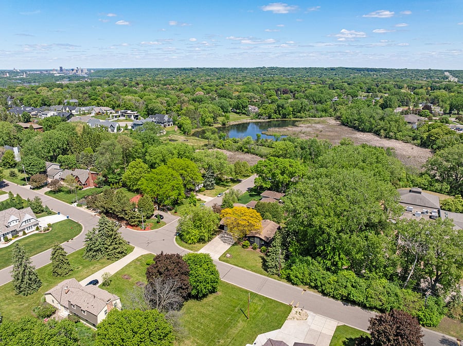 Corner forested lot on a quiet cul-de-sac, steps from nature and a small lake at the end of the street.