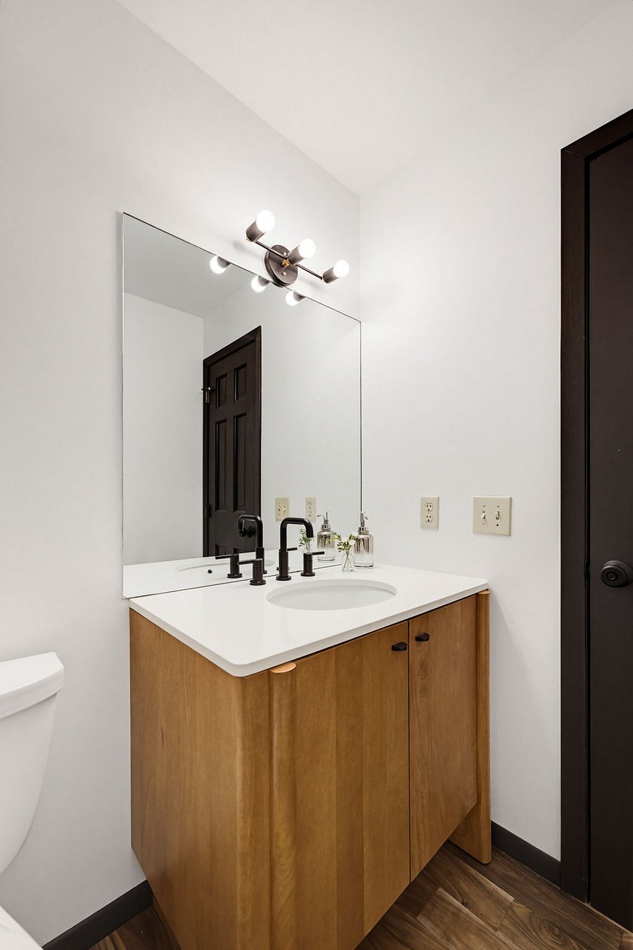 Guest powder bathroom on the main floor, conveniently located between the main entrance and the attached garage.