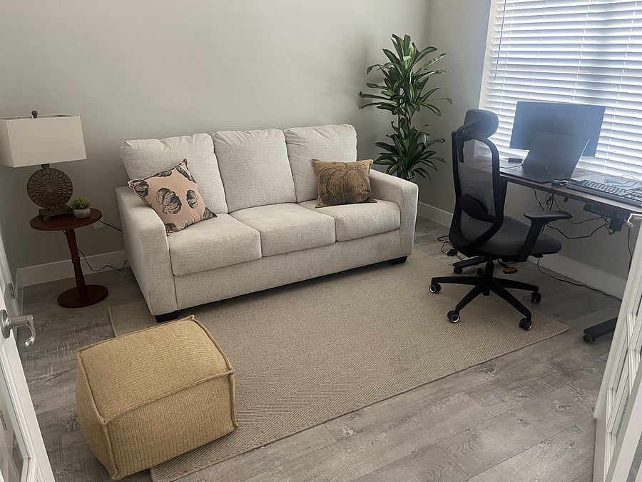 Ergonomic chair with desk adjustable for sitting or standing. Keyboard, mouse and monitor set up.