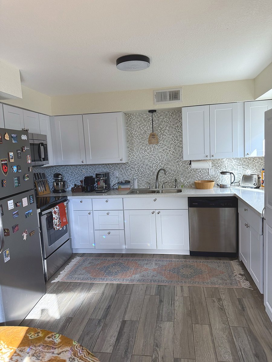 Remodeled kitchen with quartz counters and dishwasher
