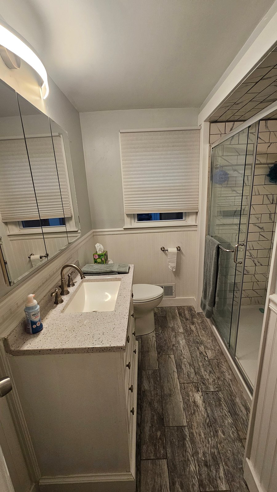 Recently renovated bathroom with glass doors and new vanity. Storage space in bathroom for personal items. Bathroom may be shared by one other tenant if there is one at the time.