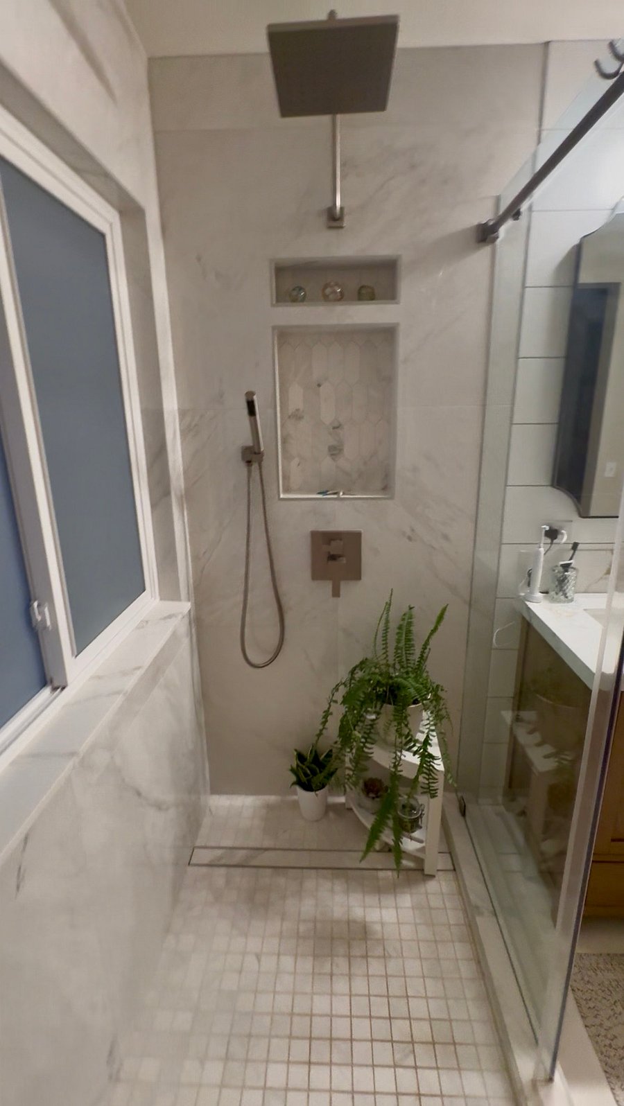 Master shower has two shower heads. This is the rain and hand wash side