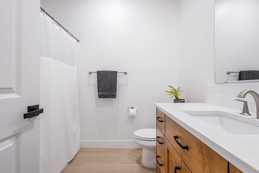 Full sized bathtub, quartz countertops.