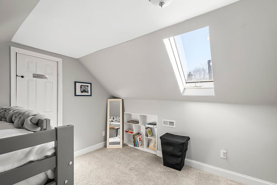 Fun and cozy: twin bunk beds, kids' books, highchair, mirror, and telescope for night sky adventures.
