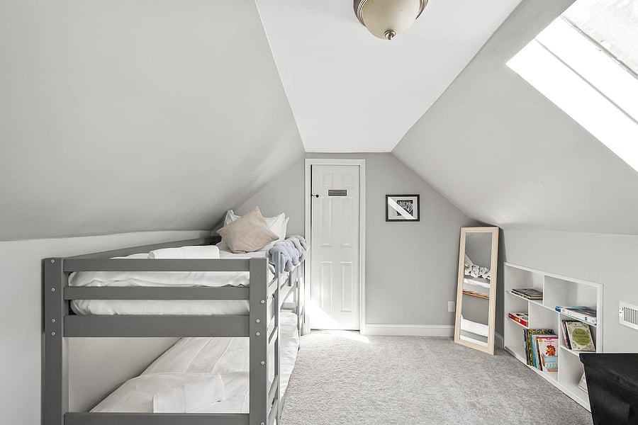 Fun bunk room with twin beds, kids' books, highchair, full-length mirror, and a telescope for stargazing through the skylight.
