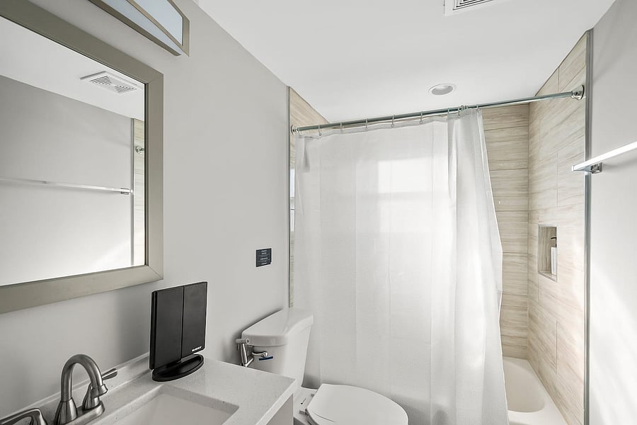 Fully stocked bathroom with hair dryer, makeup mirror, towels, Q-tips, cotton balls, and a bidet for your comfort.