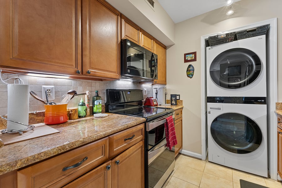 Kitchen with ample cabinet space and an in-unit washer and dryer