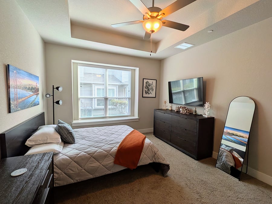 Primary bedroom with empty dresser and nightstand for your use