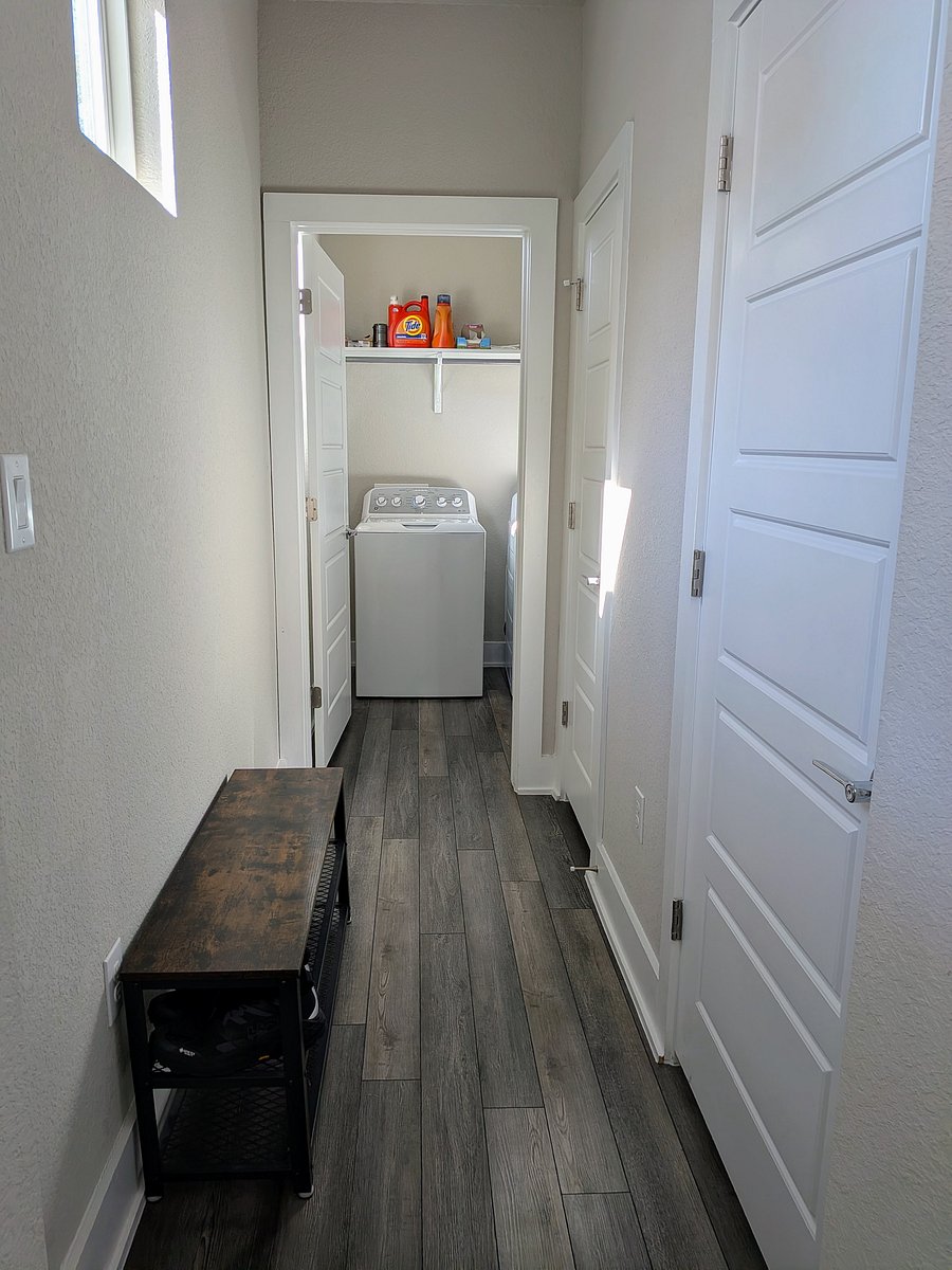 To the left of the front door, half bath, utility closet, and laundry room down the hall