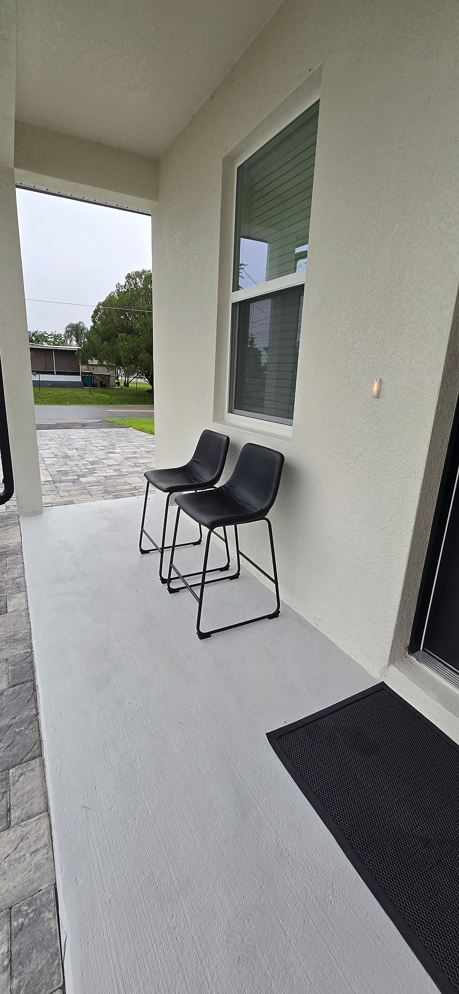 Covered front patio, perfect for fresh air and unwinding.