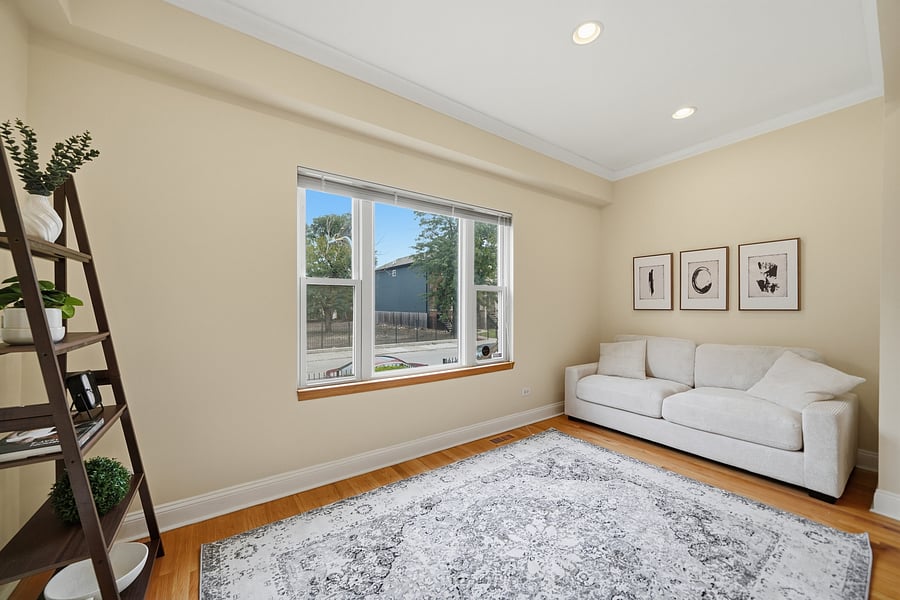 Living Room: Light-filled living room featuring gleaming hardwood floors with recessed lighting, modern neutral furnishings, and a wall-mounted TV. Perfect for unwinding after a shift.