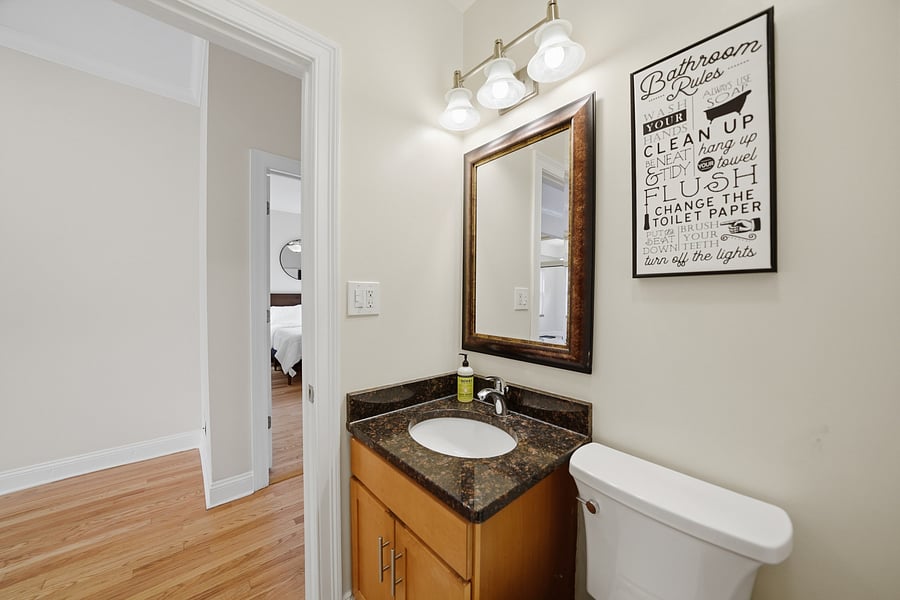 Full Bathroom: Clean, updated bathroom with a dark granite vanity top, full tub/shower surround, stylish mirror lighting, and pristine fixtures. Fresh towels provided!