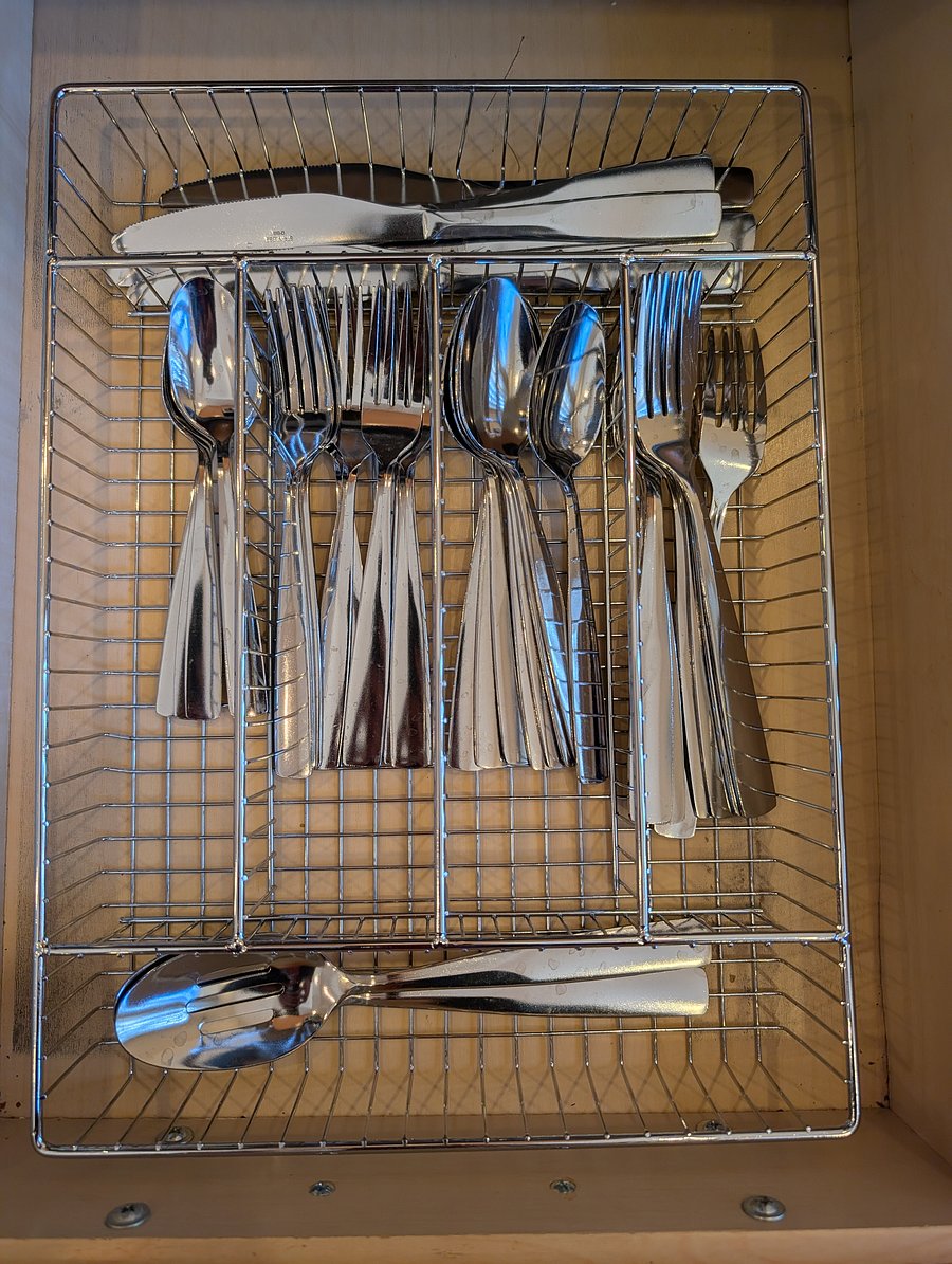 Kitchen: Clean, organized kitchen drawer fully equipped with a complete stainless steel silverware set-including forks, knives, spoons, and serving utensils. Turnkey and ready for home-cooked meals!
