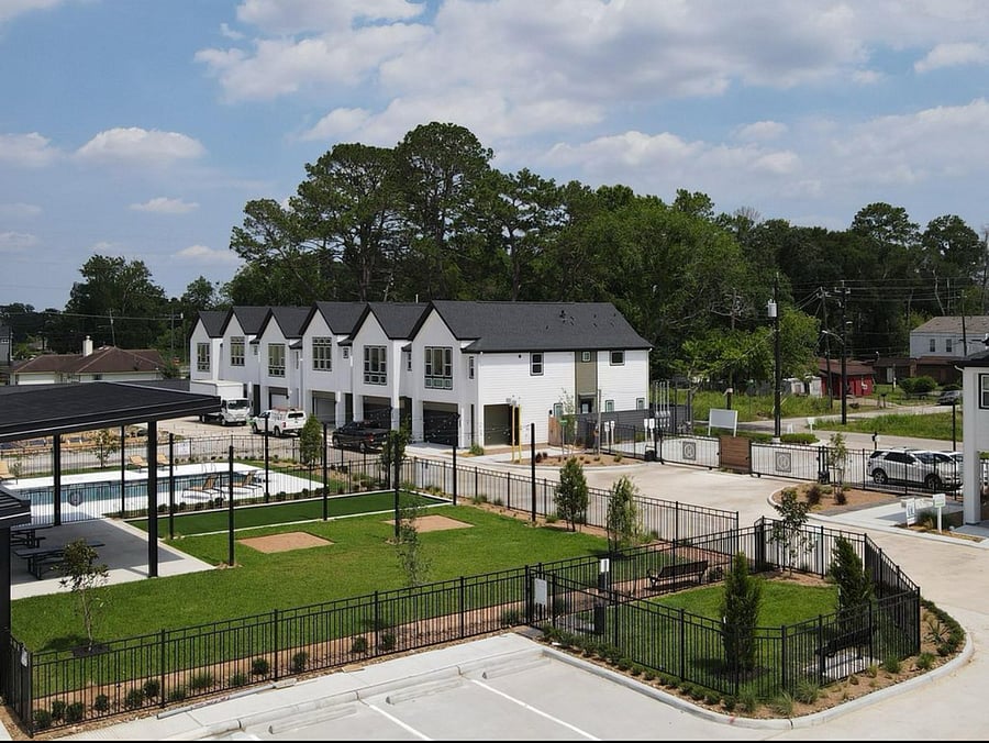 Open green space around the pool, plus a dog park in the community.