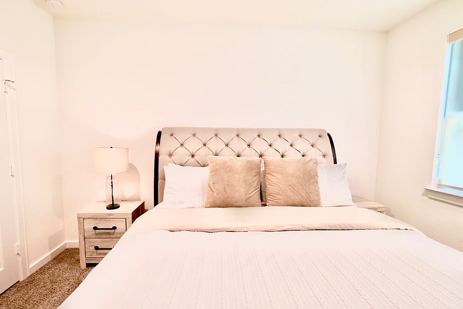Fresh linens, a bedside lamp, and a quiet room built for real rest.