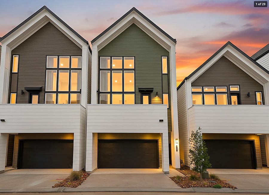 Modern, newly built townhome community at golden hour.