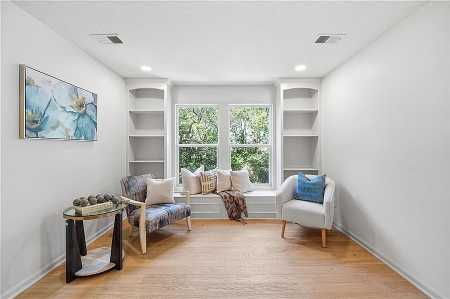 Primary suite sitting area with built-ins and window seat