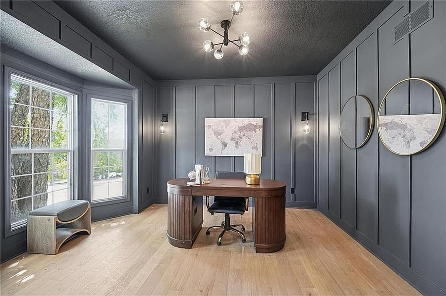 Main-level office with bay windows and paneled walls