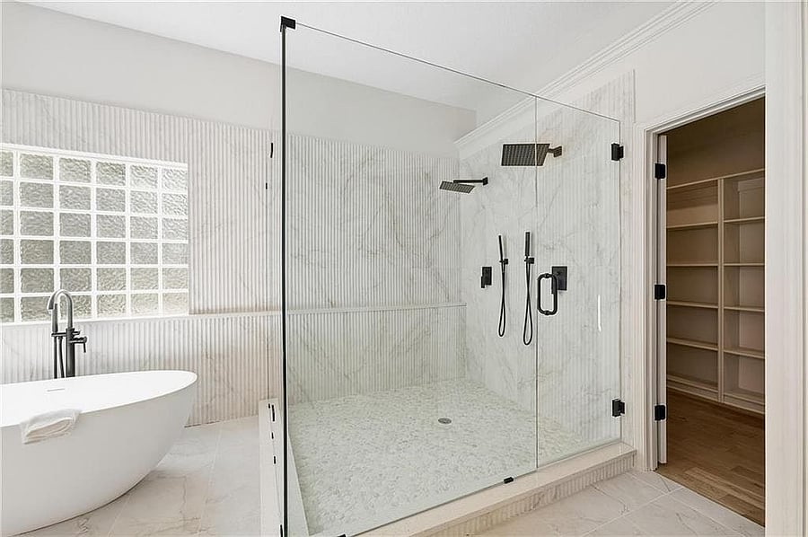 Primary bath: walk-in glass shower with dual shower heads