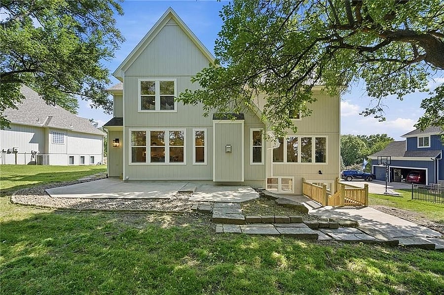 Back of the home with patio and stone steps
