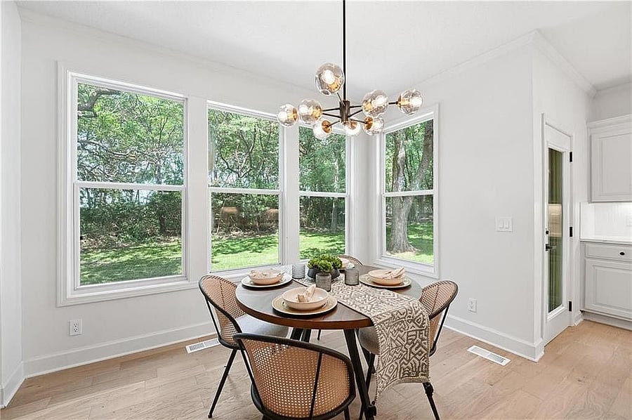 Sunny breakfast nook with a wall of windows to the backyard