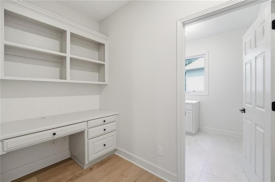 Built-in desk and shelving beside the laundry room