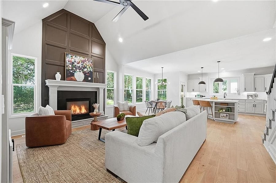 Vaulted great room with fireplace and paneled feature wall