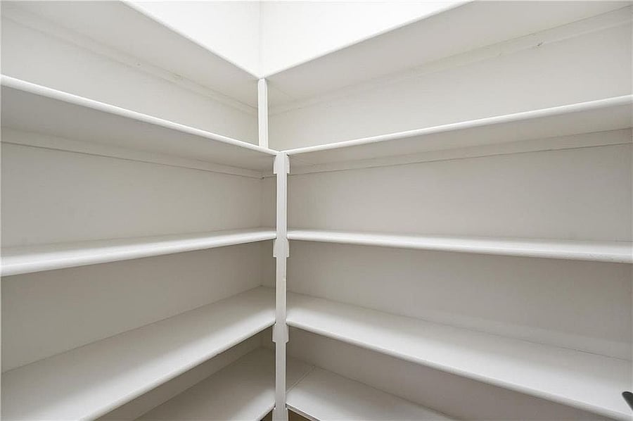 Walk-in pantry with wraparound shelving