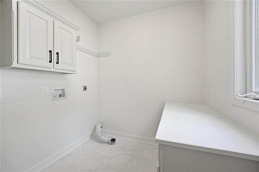 Laundry room with cabinets and counter (hookups; no machines shown)