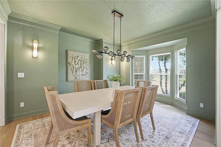 Formal dining room with chandelier and bay window