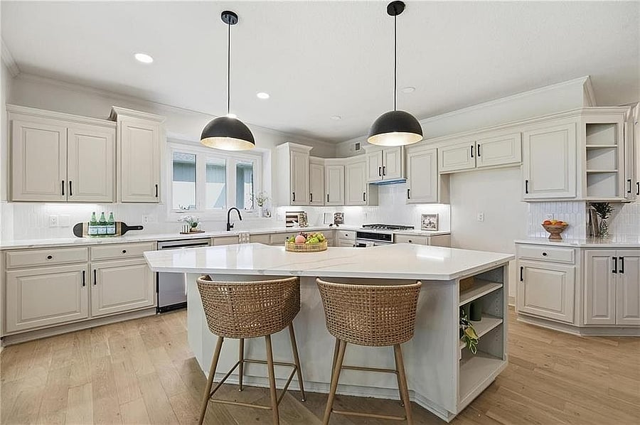 Remodeled kitchen: quartz island with seating, white cabinetry