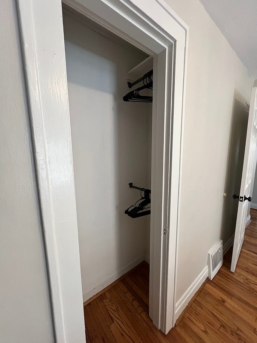 Two hanging racks for clothes in the bedroom closet. Hangers provided.