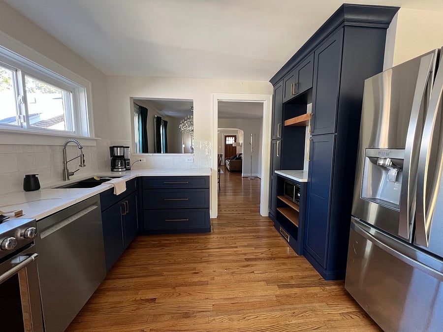 Kitchen renovated in 2024 with new cabinets, countertops, stove, and dishwasher. Beautiful wood floors are original to the house.