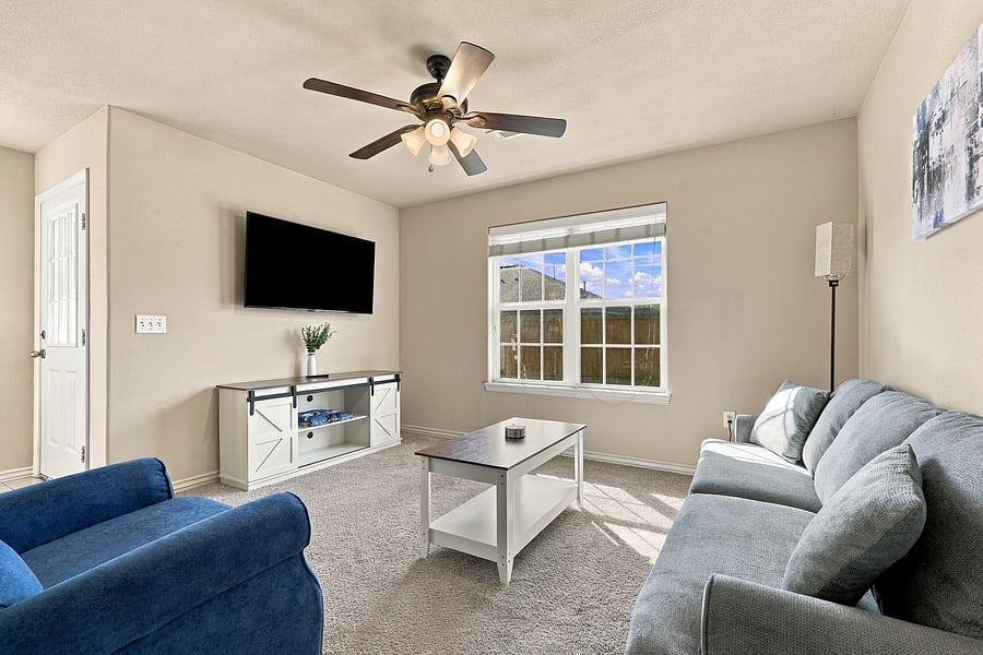 Spacious living room with 55 inch smart TV.