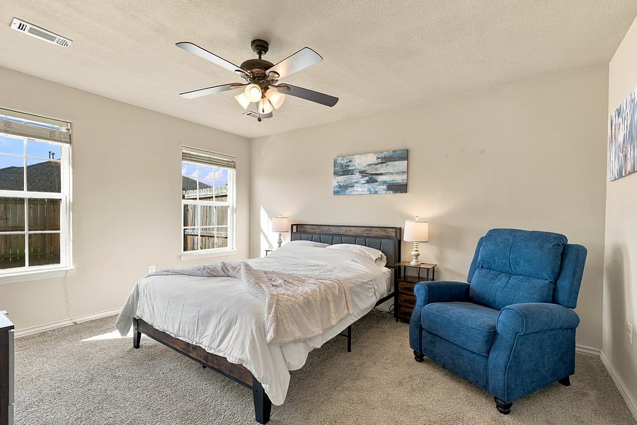 Spacious primary bedroom with queen size bed and lots of a/c outlets.